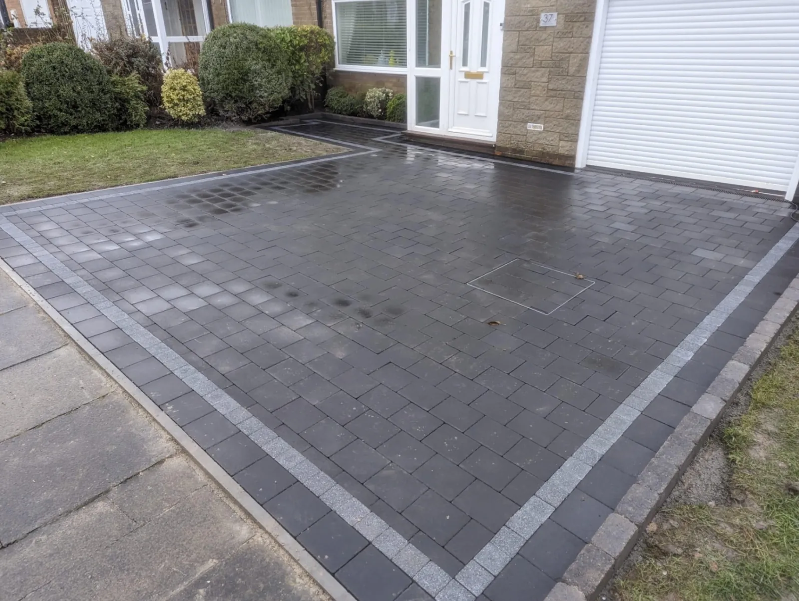 Dark block paved driveway with contrasting border