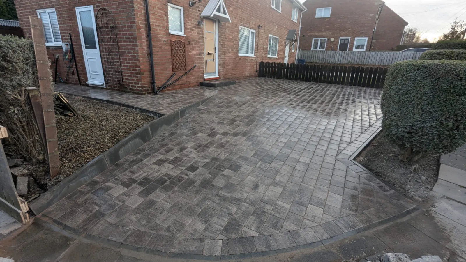 Grey block paved driveway with curved frontage