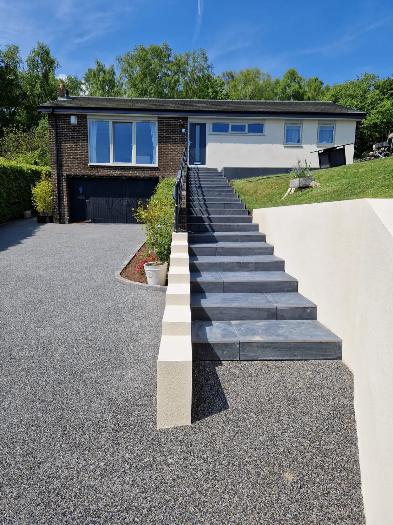 Resin driveway with slate steps and landscaping