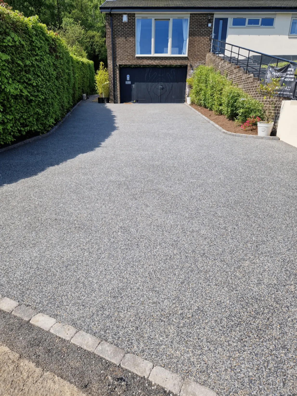Grey resin bound driveway with block edging