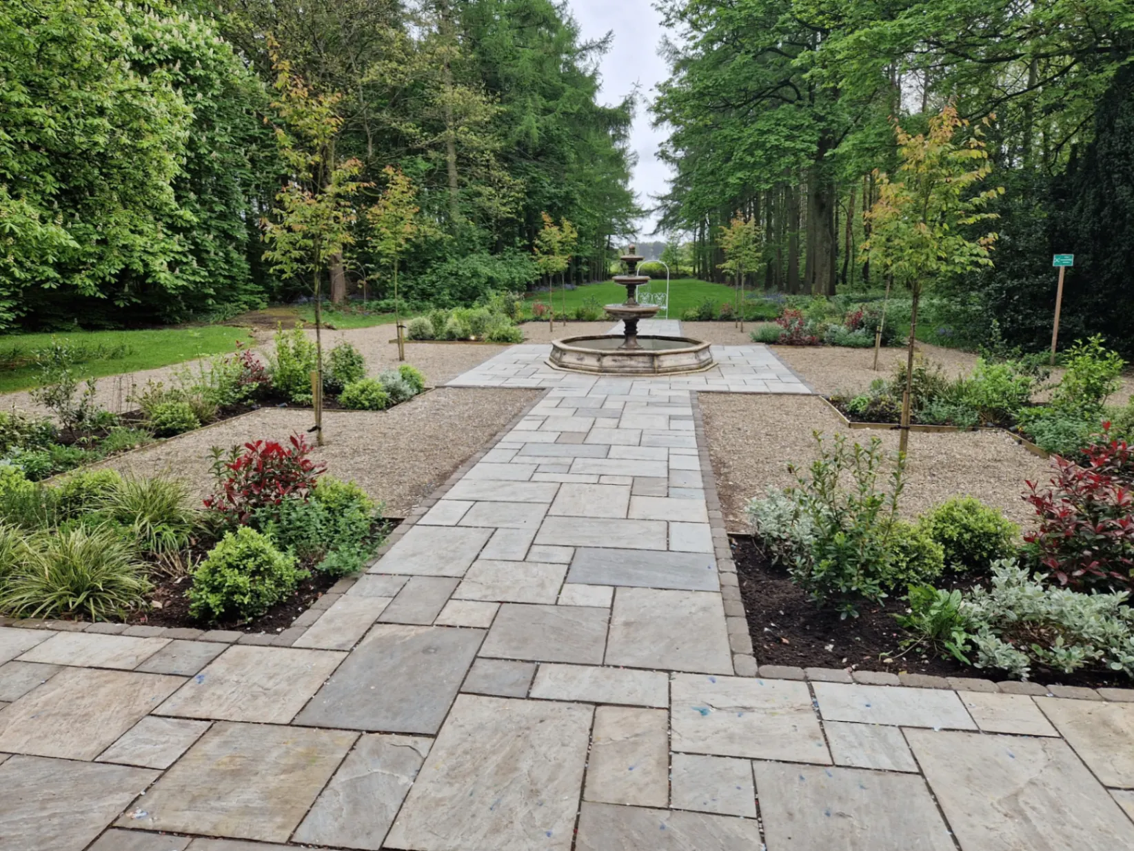 Garden pathway with fountain and landscaped borders