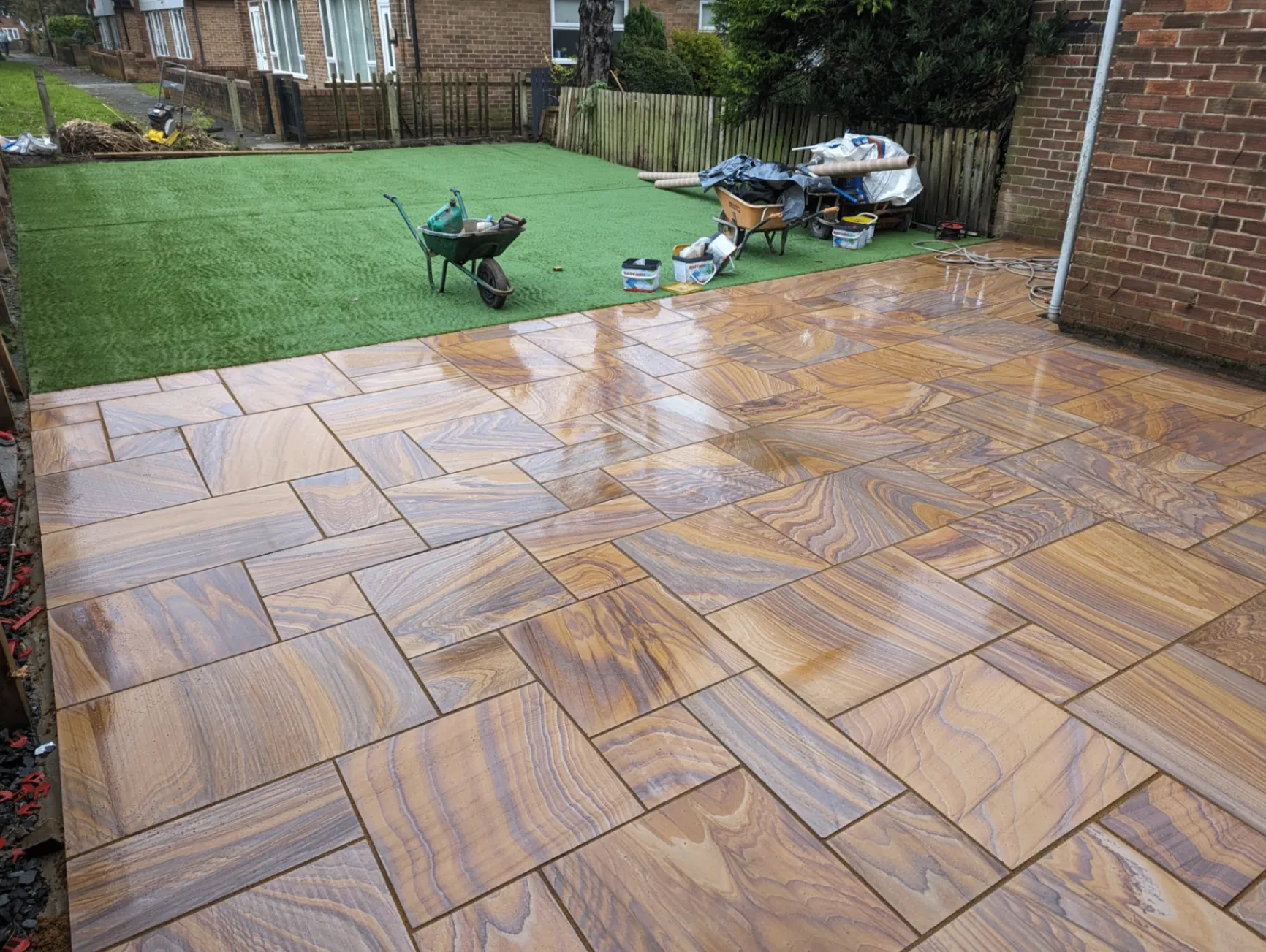 Freshly laid patterned patio with artificial lawn