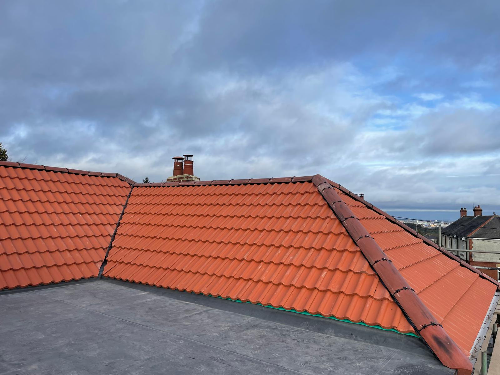 Red tiled roof section with ridge detail