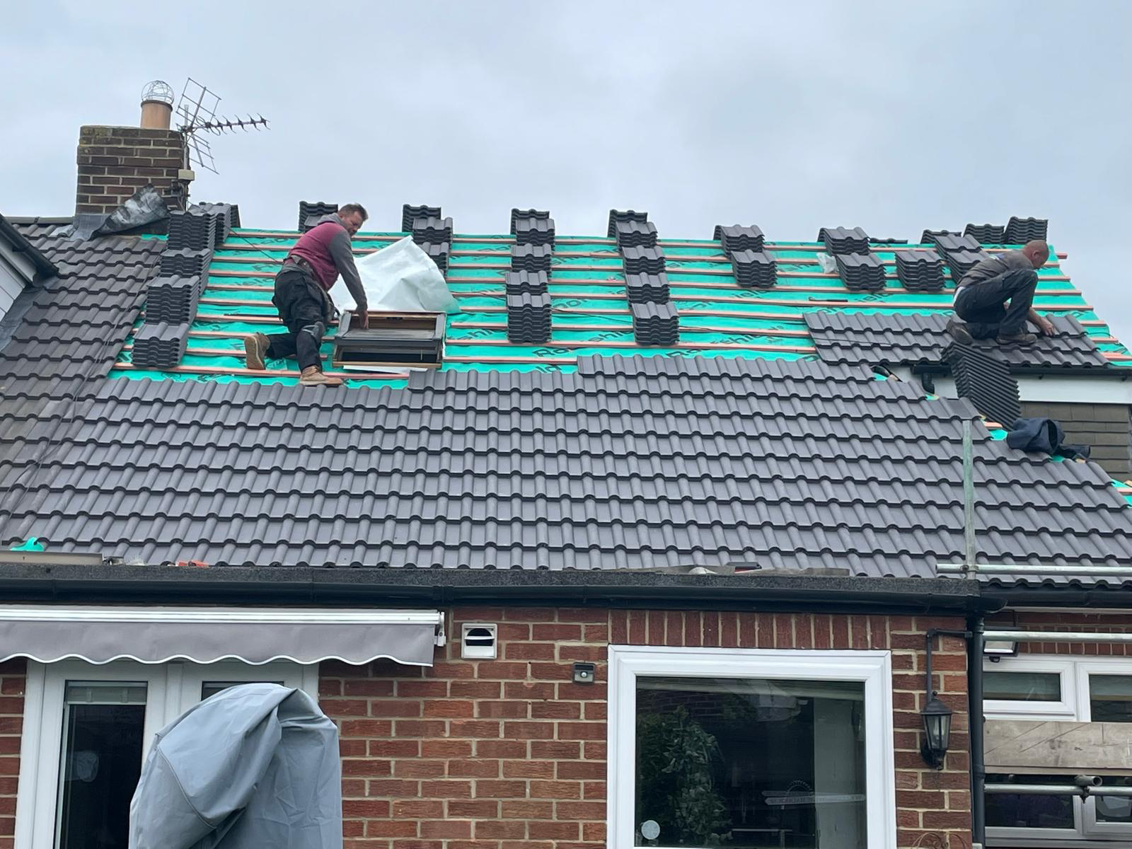 Roof installation in progress with battens and tiles