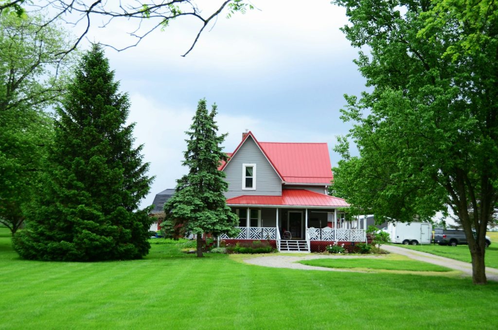 a house with a red roof surrounded by trees