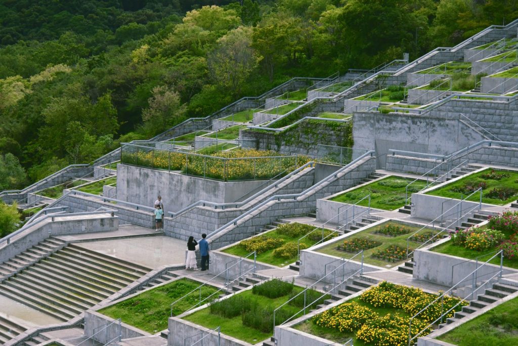 Terraced gardens with stone pathways and lush greenery.