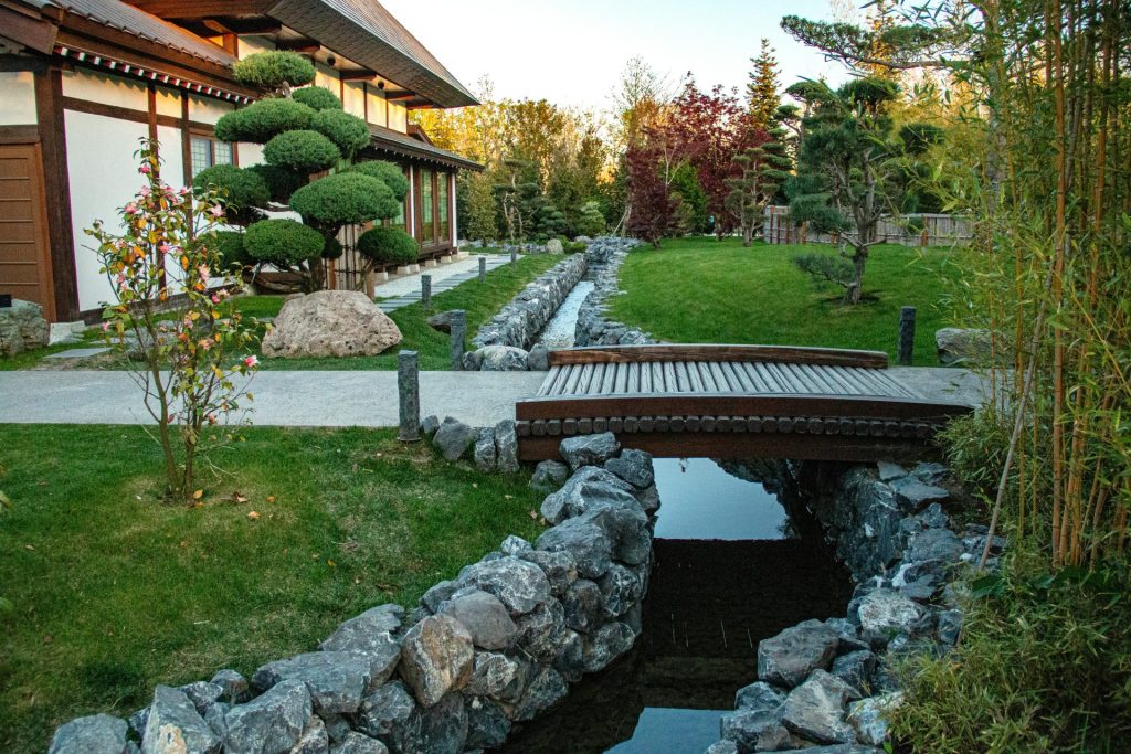 A beautiful japanese garden with a bridge.